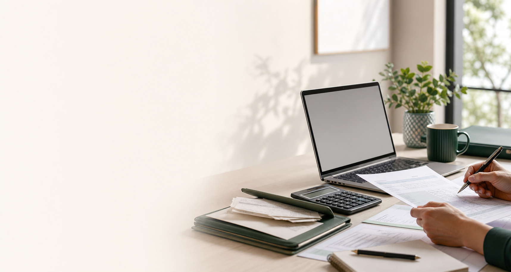 Accounting desk with tax papers, calculator and laptop